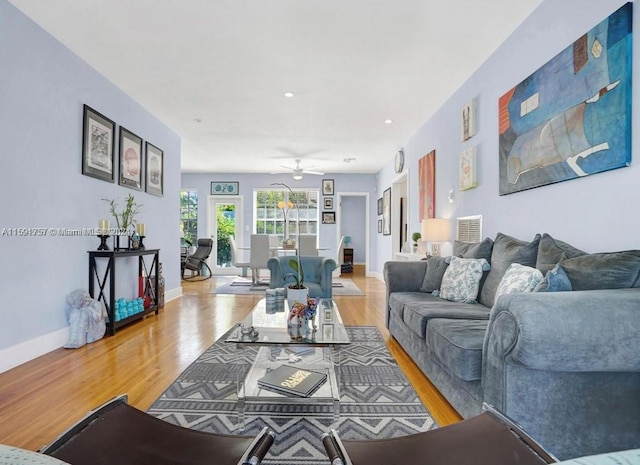 living room with ceiling fan and hardwood / wood-style flooring