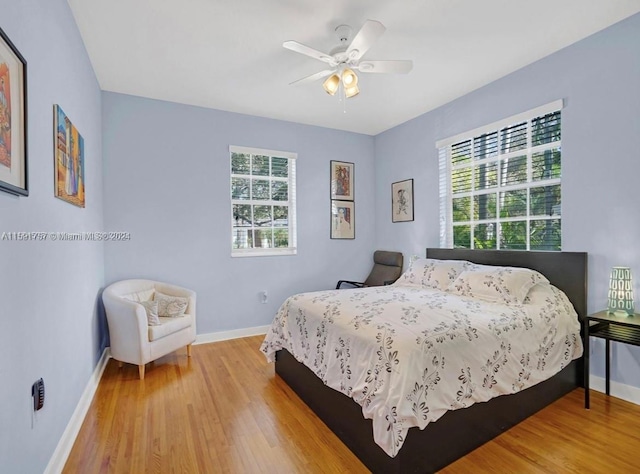 bedroom with ceiling fan and light wood-type flooring