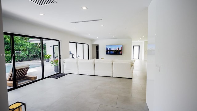 unfurnished living room with light tile patterned floors