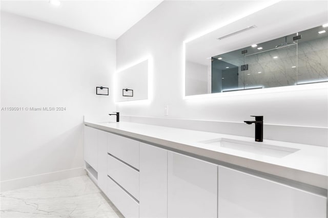 bathroom featuring a shower with shower door and vanity