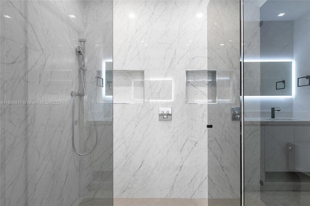 bathroom featuring vanity and a tile shower