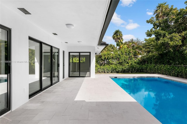 view of swimming pool with a patio area