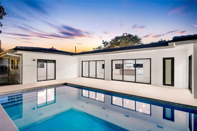 view of pool at dusk