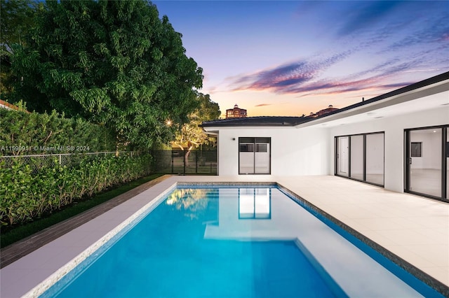 view of pool at dusk