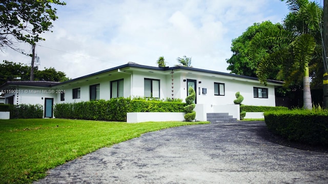 ranch-style home with a front lawn