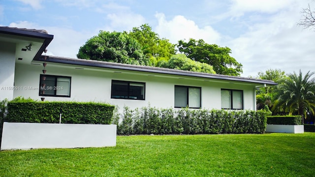 view of home's exterior with a yard