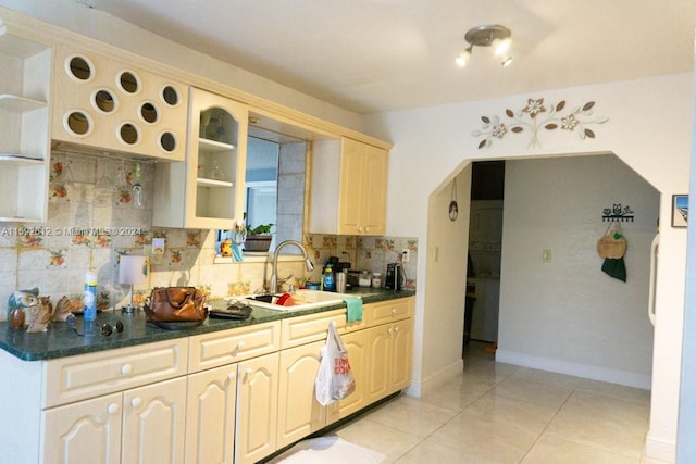 kitchen featuring sink, light brown cabinetry, tasteful backsplash, and light tile floors