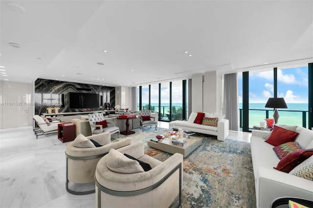 living room with light tile patterned flooring, a wealth of natural light, and floor to ceiling windows