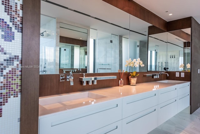 bathroom with dual vanity, tile patterned floors, and a tile shower