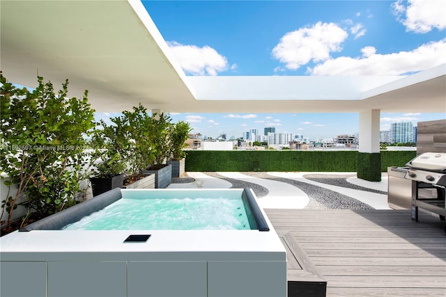 view of pool featuring an outdoor hot tub, a deck, and area for grilling