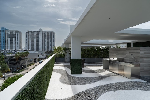 balcony featuring sink, exterior kitchen, and grilling area