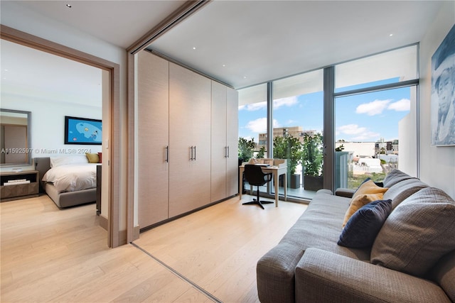 living room with floor to ceiling windows and light wood-type flooring