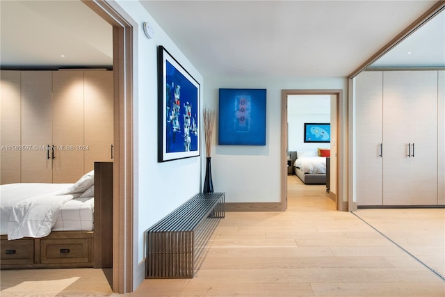 hallway with light hardwood / wood-style flooring