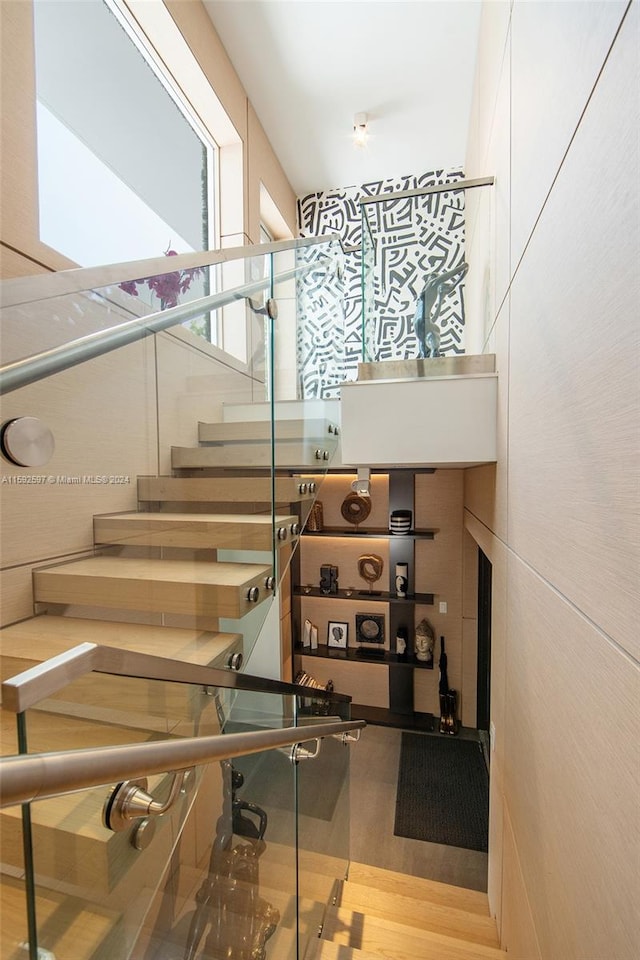 stairway featuring wood-type flooring