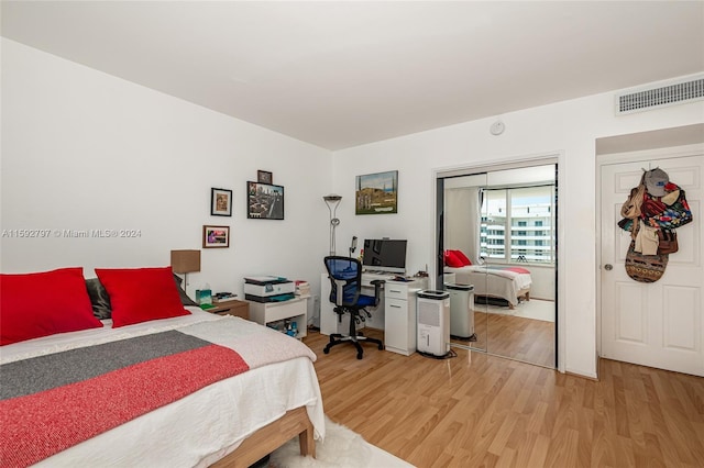 bedroom with a closet and hardwood / wood-style flooring