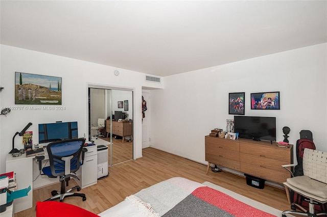 bedroom featuring a closet and light hardwood / wood-style flooring