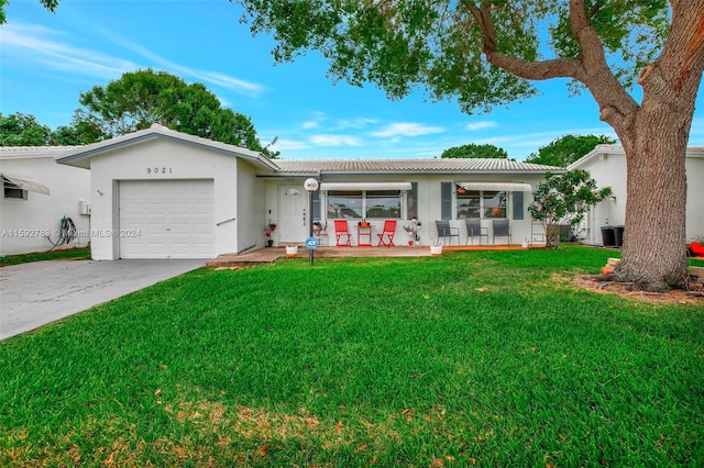 single story home with a front lawn and a garage