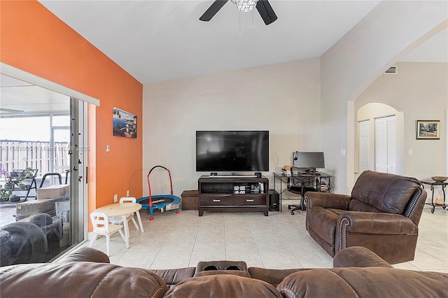 living area with light tile patterned floors, ceiling fan, vaulted ceiling, and visible vents