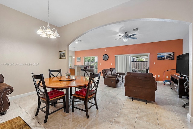 dining area featuring arched walkways, ceiling fan with notable chandelier, visible vents, and baseboards