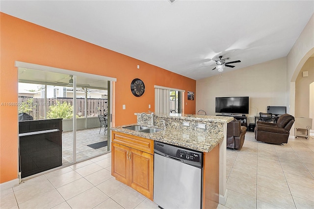 kitchen with ceiling fan, lofted ceiling, a sink, open floor plan, and dishwasher