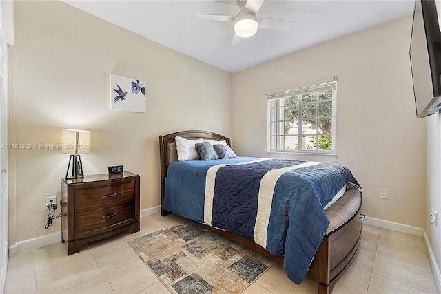 bedroom featuring a ceiling fan, light tile patterned flooring, and baseboards