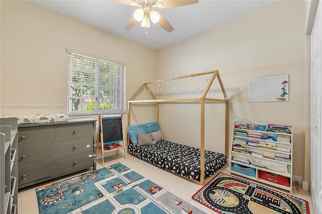 bedroom with a ceiling fan and light tile patterned flooring