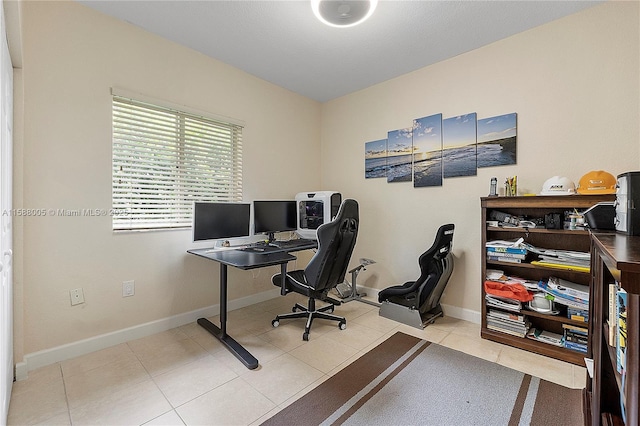 office space featuring baseboards and light tile patterned floors