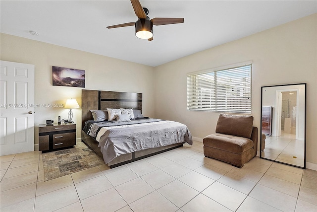 bedroom with ceiling fan, baseboards, and light tile patterned floors