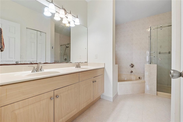 full bathroom featuring a shower stall, a sink, and tile patterned floors