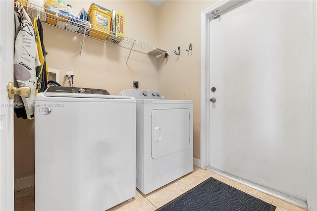 washroom featuring laundry area, light tile patterned floors, and separate washer and dryer