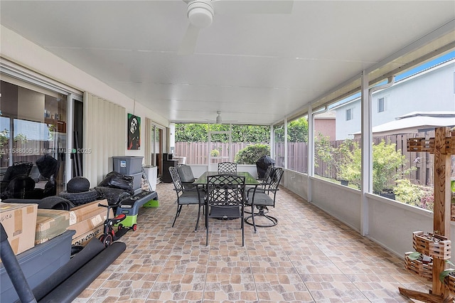 sunroom / solarium featuring ceiling fan