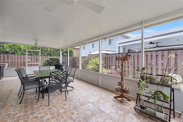 sunroom featuring a ceiling fan