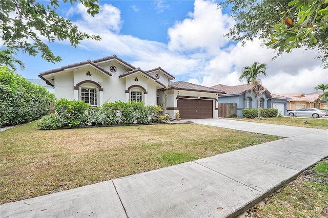 mediterranean / spanish house featuring driveway, a tile roof, a garage, and stucco siding