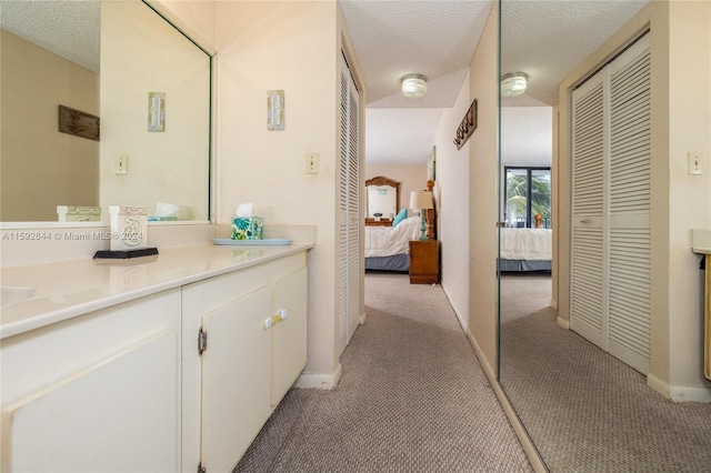 bathroom with vanity and a textured ceiling