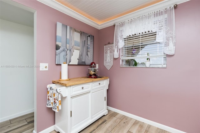 bathroom featuring hardwood / wood-style floors, ornamental molding, and vanity