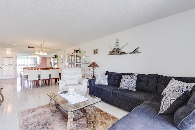 tiled living room featuring a textured ceiling