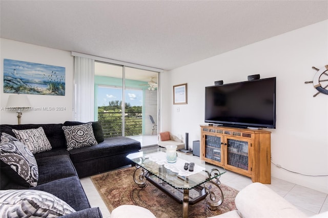 tiled living room with floor to ceiling windows and a textured ceiling