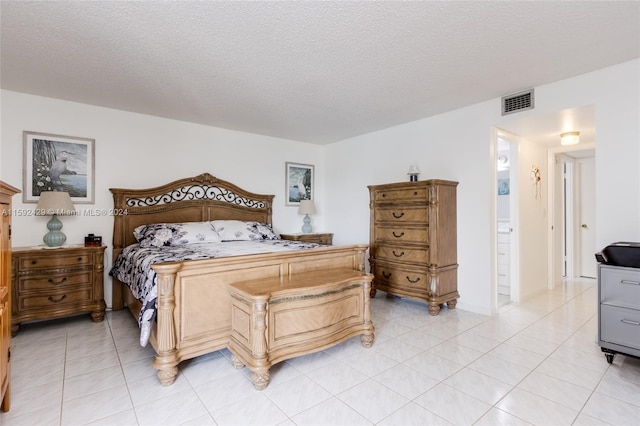 bedroom featuring a textured ceiling and light tile flooring