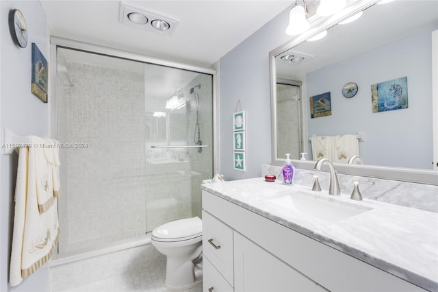 bathroom with a shower with shower door, oversized vanity, toilet, and tile floors