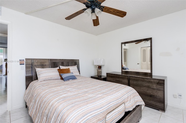 bedroom with a textured ceiling, ceiling fan, and light tile floors