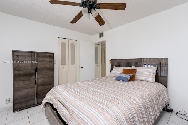 tiled bedroom with a closet and ceiling fan