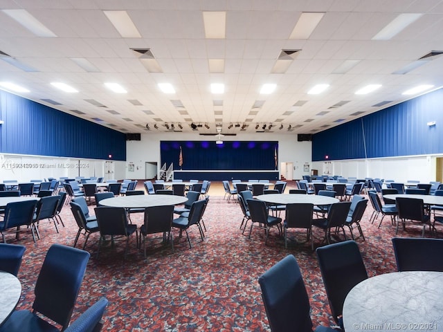 dining space featuring carpet and a paneled ceiling