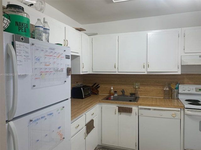 kitchen with tasteful backsplash, white appliances, custom range hood, sink, and white cabinetry