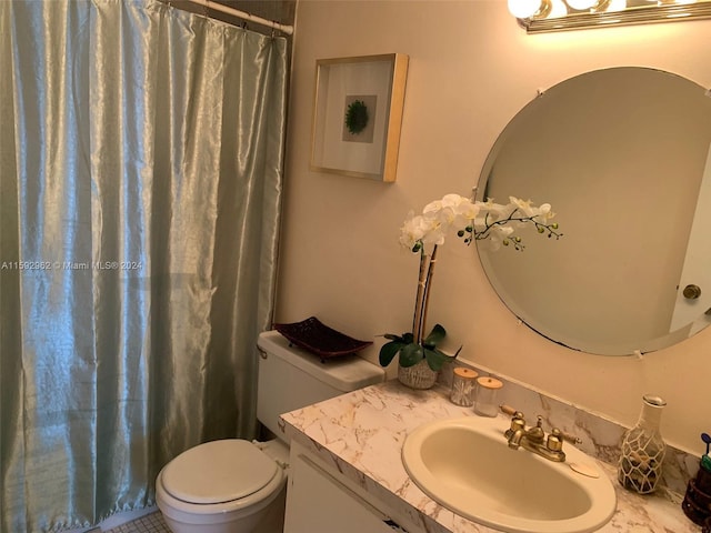 bathroom with tile flooring, oversized vanity, and toilet