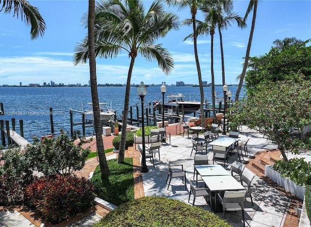 view of patio / terrace featuring a water view and a dock