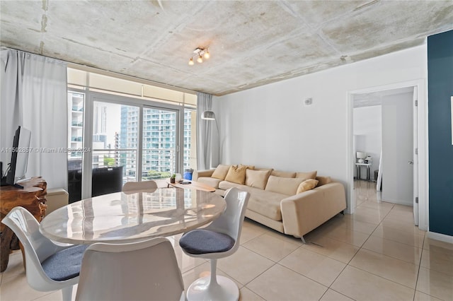 tiled dining area featuring a wall of windows