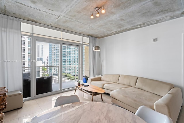 living room featuring expansive windows and light tile floors