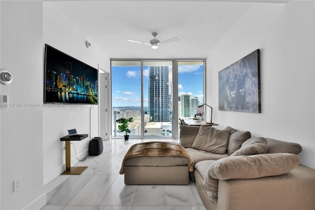 tiled living room featuring ceiling fan and floor to ceiling windows