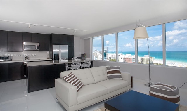 living room featuring a water view and rail lighting