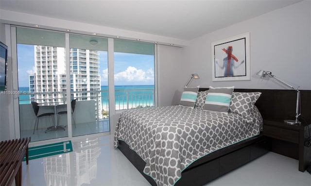 bedroom with access to exterior and a water view